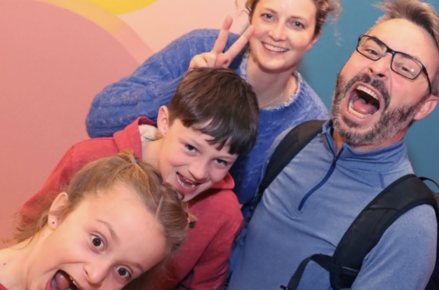 Jason with his wife and two kids, making silly faces for the camera